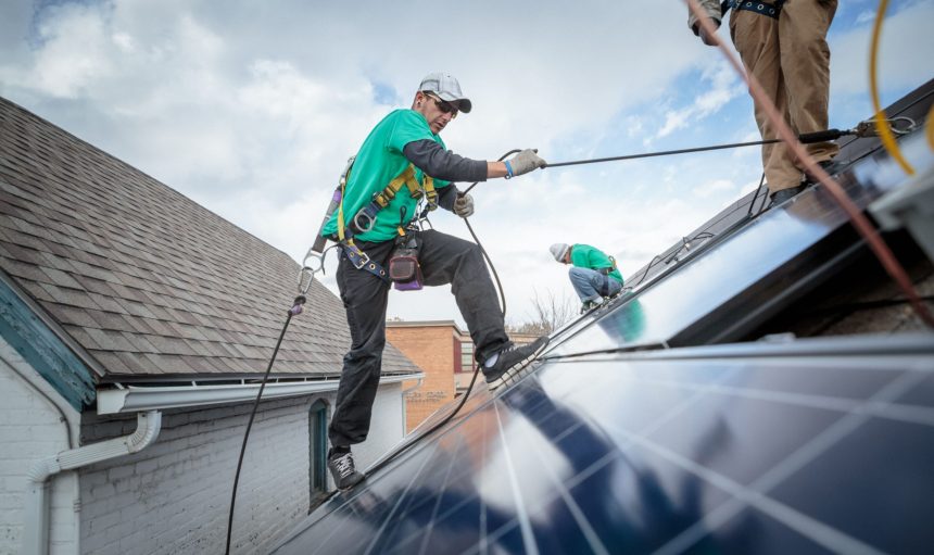 construction-crew-installing-solar-panels-on-a-hou-2024-10-18-10-01-48-utc
